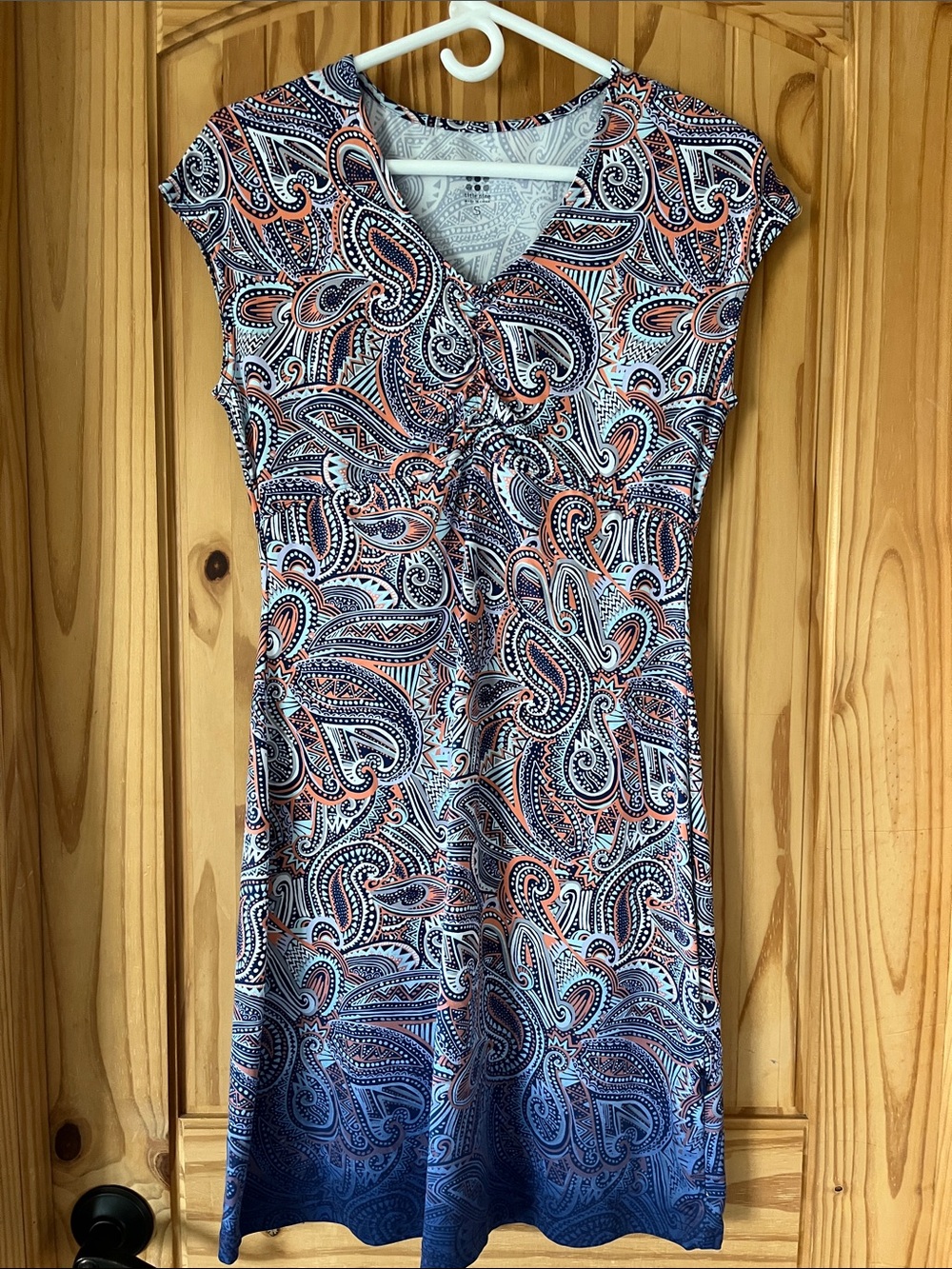 Title Nine Paisley V-Neck Dress in Navy, Coral, White, and ombre at the bottom.